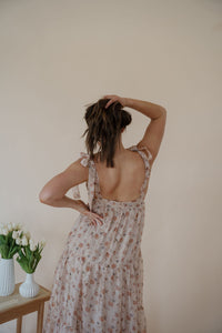 close back view of model wearing the everything could change dress. model has the dress paired with the anna necklace.