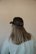 Load image into Gallery viewer, back view of model wearing the yeehaw trucker hat. model has the hat paired with the never be the same shacket and the change your mind bodysuit in the color smoky taupe.