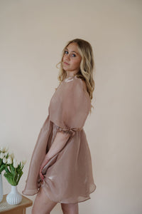 side view of model wearing the wherever you go dress. model has the dress paired with the dainty mallory necklace.