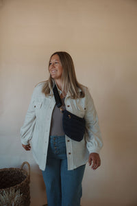 front view of model wearing the never be the same shacket. model has the shacket paired with the change your mind bodysuit in the color smoky taupe and the it girl crossbody in the color navy.