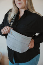 Load image into Gallery viewer, detail view of model wearing the it girl crossbody in the color grey. model has the bag paired with the play by my rules top in the color black.