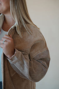 detail view of model wearing the all we could be jacket. model has the sweater paired with the change your mind bodysuit in the color white.