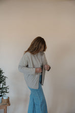 Load image into Gallery viewer, side view of model wearing the one more day jacket. model has the sweater paired with the genevive denim.