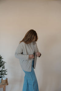 side view of model wearing the one more day jacket. model has the sweater paired with the genevive denim.