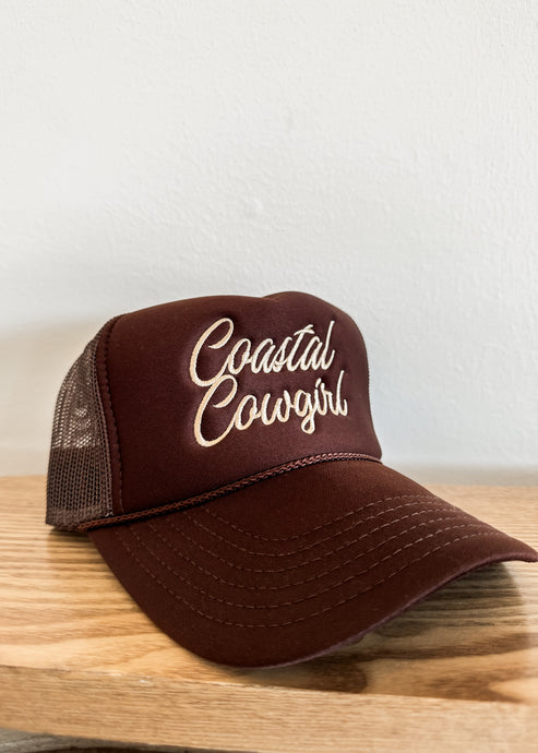 coastal cowgirl trucker hat. brown trucker style hat with cream embroidered words “coastal cowgirl” in script font.
