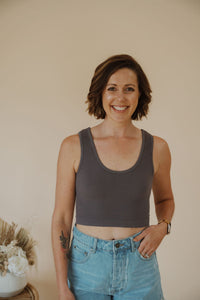 front view of model wearing the stay the same top in the color charcoal. model has the top paired with the boston denim shorts.