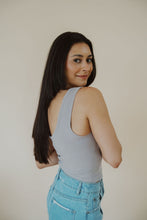 Load image into Gallery viewer, side view of model wearing the stay the same top in the color chrome. model has the top paired with the boston denim shorts.