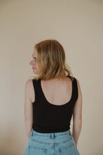 Load image into Gallery viewer, back view of model wearing the stay the same top in the color black. model has the top paired with the dakota denim shorts.