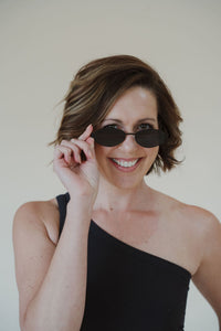 front view of model wearing the soho sunglasses in the color black.
