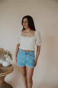 front view of model wearing the note to self top. model has the top paired with the boston denim shorts.