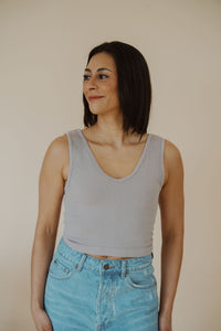 front view of model wearing the stay the same top in the color chrome. model has the top paired with the boston denim shorts.