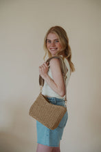 Load image into Gallery viewer, model wearing the weekend getaway bag in the color tan. model has the adjustable crossbody strap attached.