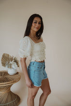 Load image into Gallery viewer, side view of model wearing the note to self top. model has the top paired with the boston denim shorts.
