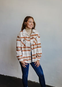 model wearing the suddenly I see shacket in the color terra plaid. model has the shacket paired with the can't get enough top in the color oatmeal and a pair of dark wash denim.