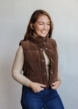 Load image into Gallery viewer, model wearing the what could have been vest in the color cocoa. model has the vest paired with the can&#39;t get enough top in the color oatmeal and a pair of dark wash jeans.