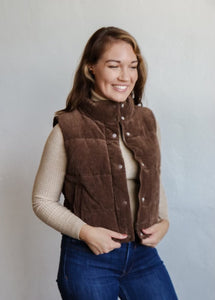 model wearing the what could have been vest in the color cocoa. model has the vest paired with the can't get enough top in the color oatmeal and a pair of dark wash jeans.