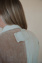 Load image into Gallery viewer, detail view of model wearing the all we could be jacket. model has the sweater paired with the change your mind bodysuit in the color white.