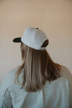 Load image into Gallery viewer, back view of model wearing the country and western trucker hat. model has the hat paired with the never be the same shacket and the change your mind bodysuit in the color smoky taupe.