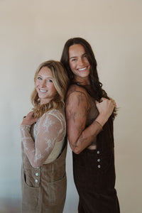 side view of models wearing the settlin' down corduroy overalls. models have the overalls paired with the here to stay top.