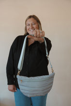 Load image into Gallery viewer, front view of model holding the it girl crossbody in the color grey. model has the bag paired with the play by my rules top in the color black.