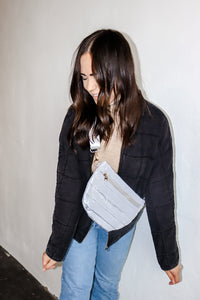 model wearing the it girl crossbody in the color grey.