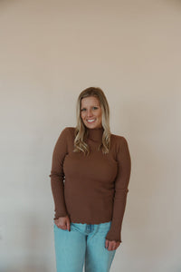 front view of model wearing the until you top in the color caramel. model has the top paired with the charleston denim.