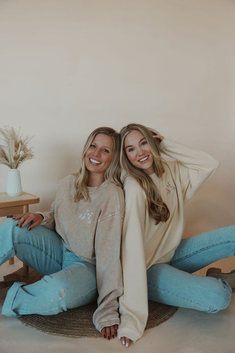 front view of models wearing the t+e corded crewneck in the colors latte and cream. models have the crewneck paired with the charleston denim.