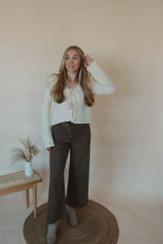 Load image into Gallery viewer, front view of model wearing the addison denim in the color brown. model has the denim paired with the everything to me sweater.