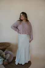 Load image into Gallery viewer, front view of model wearing the cherish satin maxi in the color ivory. model has the skirt paired with the devoted sweater.