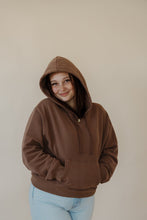 Load image into Gallery viewer, front view of model wearing the something more sweatshirt in the color chocolate. model has the sweatshirt paired with the camden denim.