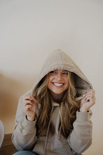 Load image into Gallery viewer, front view of model wearing the something more sweatshirt in the color taupe. model has the sweatshirt paired with the Hartford denim.