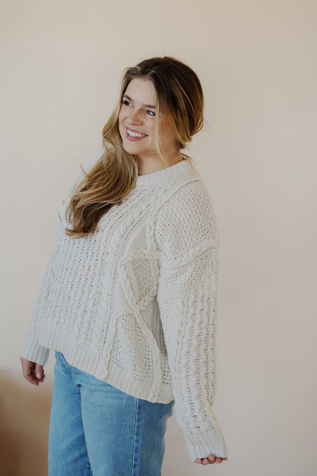 side view of model wearing the my way back home sweater in the color ivory. model has the sweater paired with the Hartford denim.