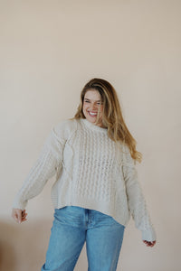 front view of model wearing the my way back home sweater in the color ivory. model has the sweater paired with the Hartford denim.