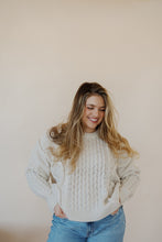 Load image into Gallery viewer, front view of model wearing the my way back home sweater in the color ivory. model has the sweater paired with the Hartford denim.