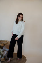 Load image into Gallery viewer, front view of model wearing the Addison denim in the color fade black. model has the denim paired with the somewhere in the middle sweater in the color white.