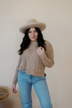 Load image into Gallery viewer, front view of model wearing the somewhere in the middle sweater in the color oat. model has the sweater paired with the Hartford denim.