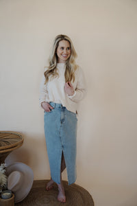 front view of model wearing the as long as I live denim midi skirt. model has the skirt paired with the halfway there top.