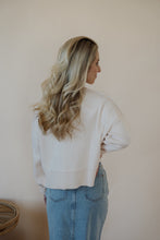 Load image into Gallery viewer, back view of model wearing the halfway there sweater in the color cream. model has the sweater paired with the as long as I live denim midi skirt.