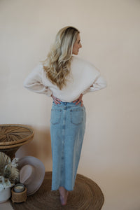 back view of model wearing the as long as I live denim midi skirt. model has the skirt paired with the halfway there top.