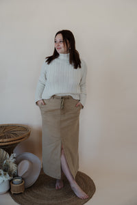 front view of model wearing the in another life skirt. model has the skirt paired with the every moment sweater in the color ivory.