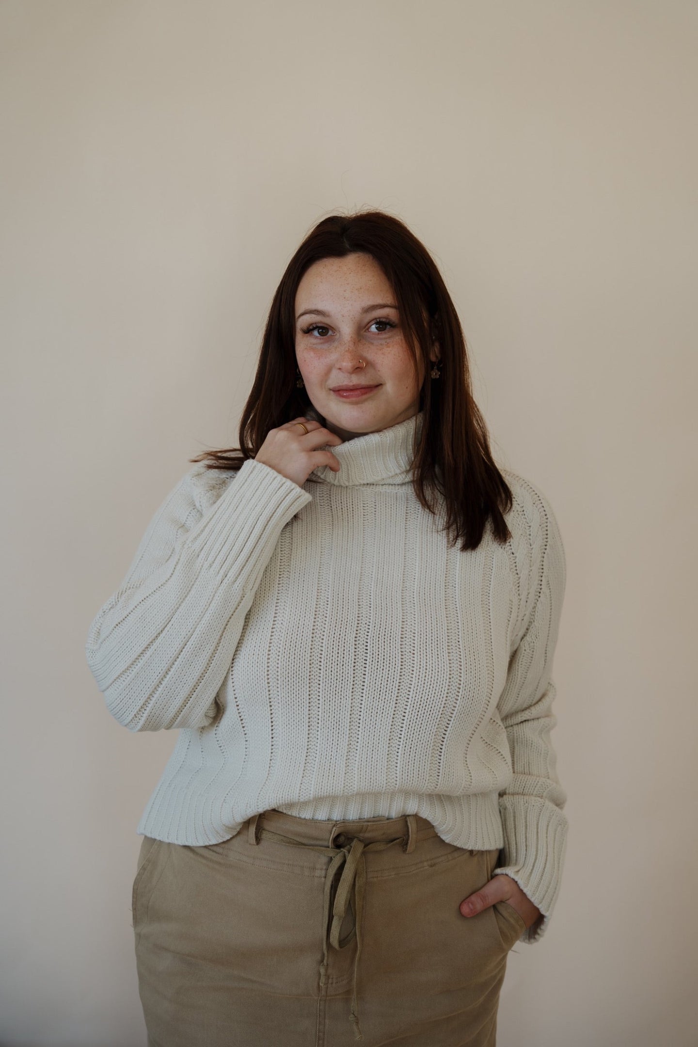 front view of model wearing the every moment sweater in the color ivory. model has the sweater paired with the in another life skirt.