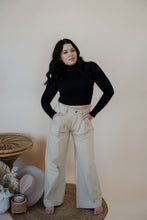 Load image into Gallery viewer, front view of model wearing the Oakland chinos. model has the chinos paired with the after all top in the color black.