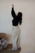 Load image into Gallery viewer, back/side view of model wearing the Oakland chinos. model has the chinos paired with the after all top in the color black.