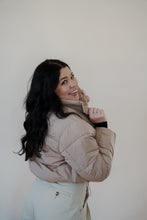 Load image into Gallery viewer, back view of model wearing the time after time puffer in the color khaki. model has the puffer paired with the all along top in the color black and the oakland chinos.