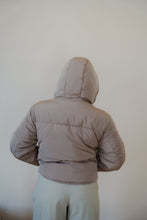 Load image into Gallery viewer, back view of model wearing the where it all began puffer in the color khaki. model has the puffer paired with the all along top in the color black and the oakland chinos.