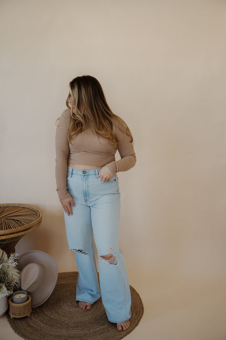 front view of model wearing the Camden denim. model has the denim paired with the after all top in the color almond.