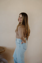 Load image into Gallery viewer, side view of model wearing the after all top in the color almond. model has the top paired with the Camden denim.