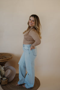 side view of model wearing the Camden denim. model has the denim paired with the after all top in the color almond.