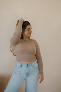 front view of model wearing the after all top in the color almond. model has the top paired with the Camden denim.