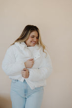 Load image into Gallery viewer, front view of model wearing the where it all began puffer in the color ivory. model has the puffer paired with the all along top in the color almond and the camden denim.